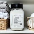 Mahogany Cedarwood laundry scent booster bottle with folded towels