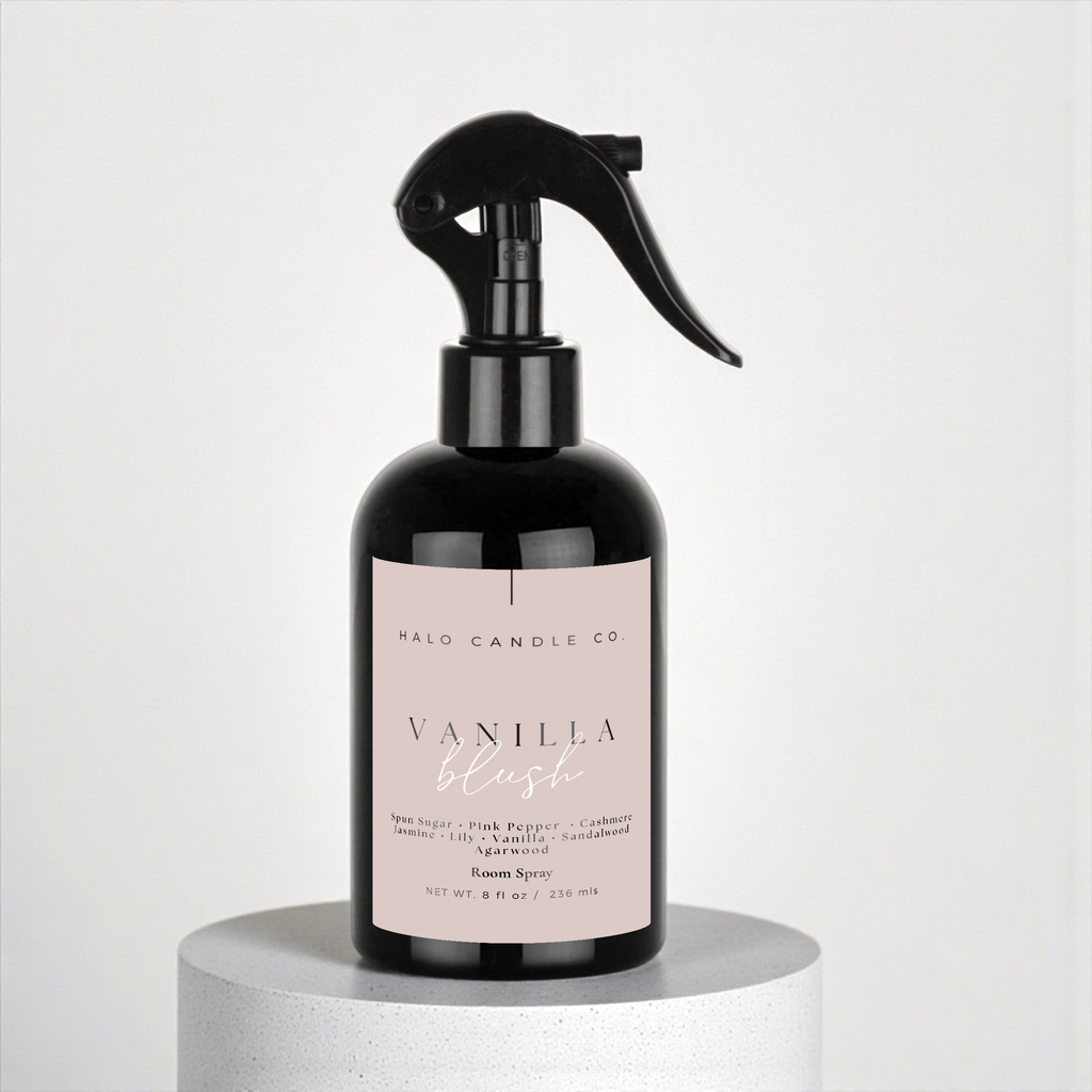 Black spray bottle with pink label on a white background