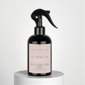 Black spray bottle with pink label on a white background